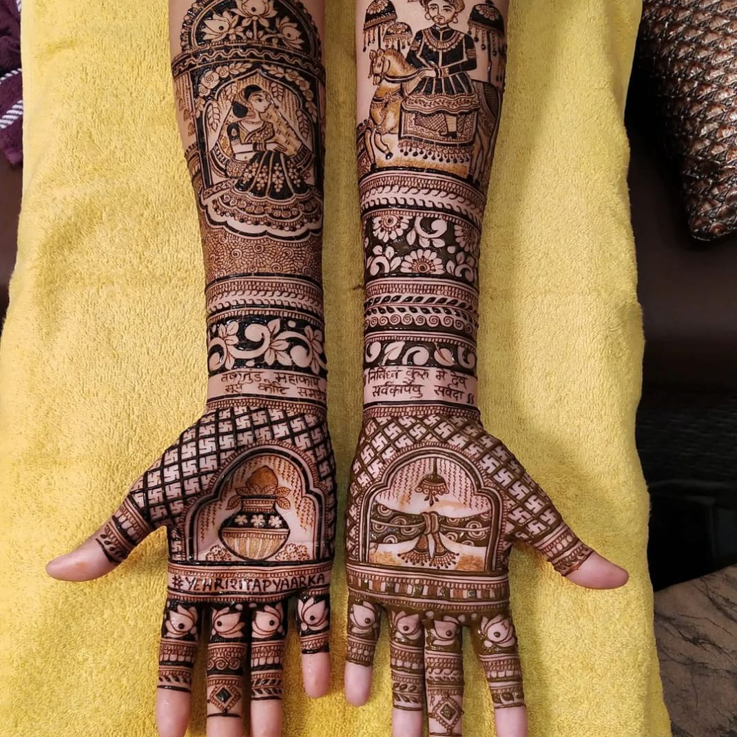 Professional artist applying hand Mehandi designs with organic henna