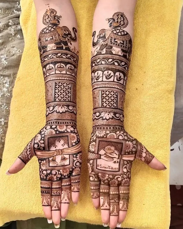 Professional artist applying hand Mehandi designs with organic henna